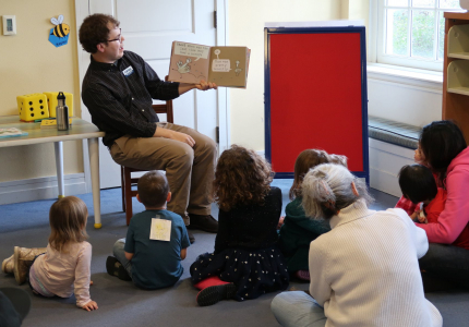 storytime reading a book to an audience of toddlers