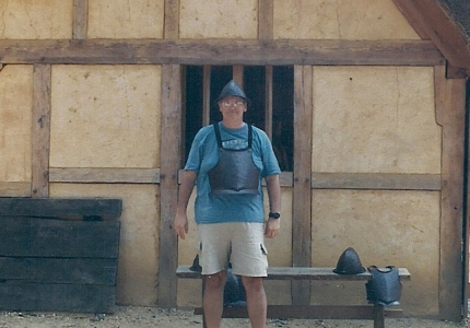 man with tee shirt, shorts and armor