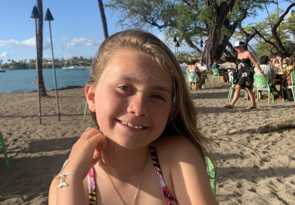 A smiling girl on a sunny beach