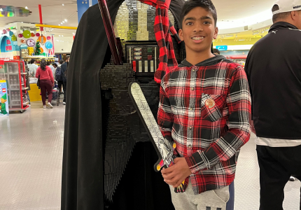 Narayhan standing next to a life-size character from Star Wars made out of LEGOs