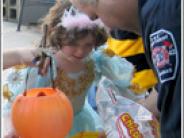 Fire fighter handing candy to a trick-or-treater