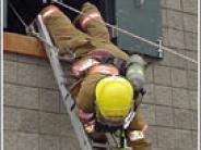 Firefighter climbing down a ladder