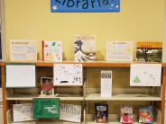 Children's book display with coloring pages and a poster