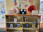 Picture of bookshelves with books and flower decorations