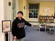 Lucas standing at the entrance of the Early Learning Center, guiding us to his Kid Librarian display