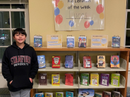 Lucas standing next to his display