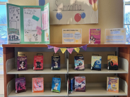 Bookshelves with books and posters on display