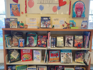Bookshelves with books and art pieces on display