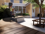 Camas Public Library courtyard, featuring a curved wooden bench with donor plaques and people interacting in the outdoor space