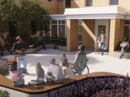 Camas Library courtyard with people listening to a guitarist, surrounded by seating, trees, and plants
