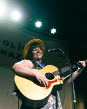Emma Hill Playing Guitar on stage