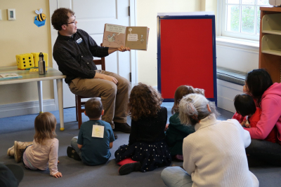 storytime reading a book to an audience of toddlers