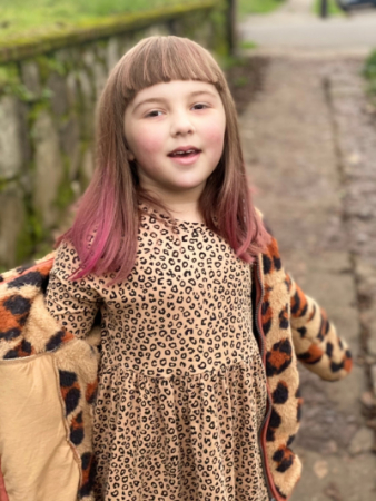 Little girl outside with arms outstretched