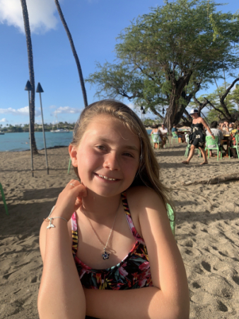 A smiling girl on a sunny beach
