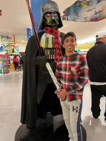 Narayhan standing next to a life-size character from Star Wars made out of LEGOs