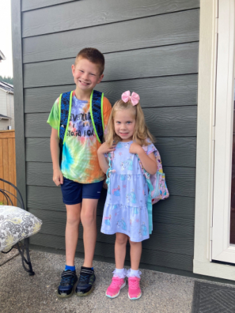 Skyler and Madison standing next to each other wearing backpacks