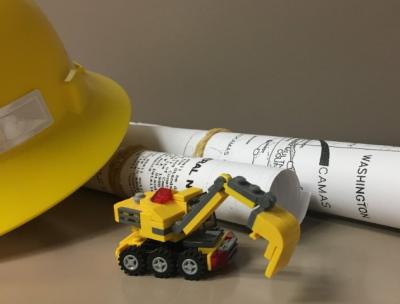 Construction hat, plans, and toy car